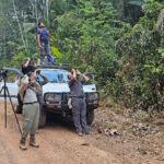 Team a watching Crimson Fruitcrow in the Iwokrama forest reserve (image by Eustace Barnes)